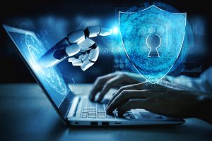 Cybersécurité : main robotique sortant d'un écran de PC portable